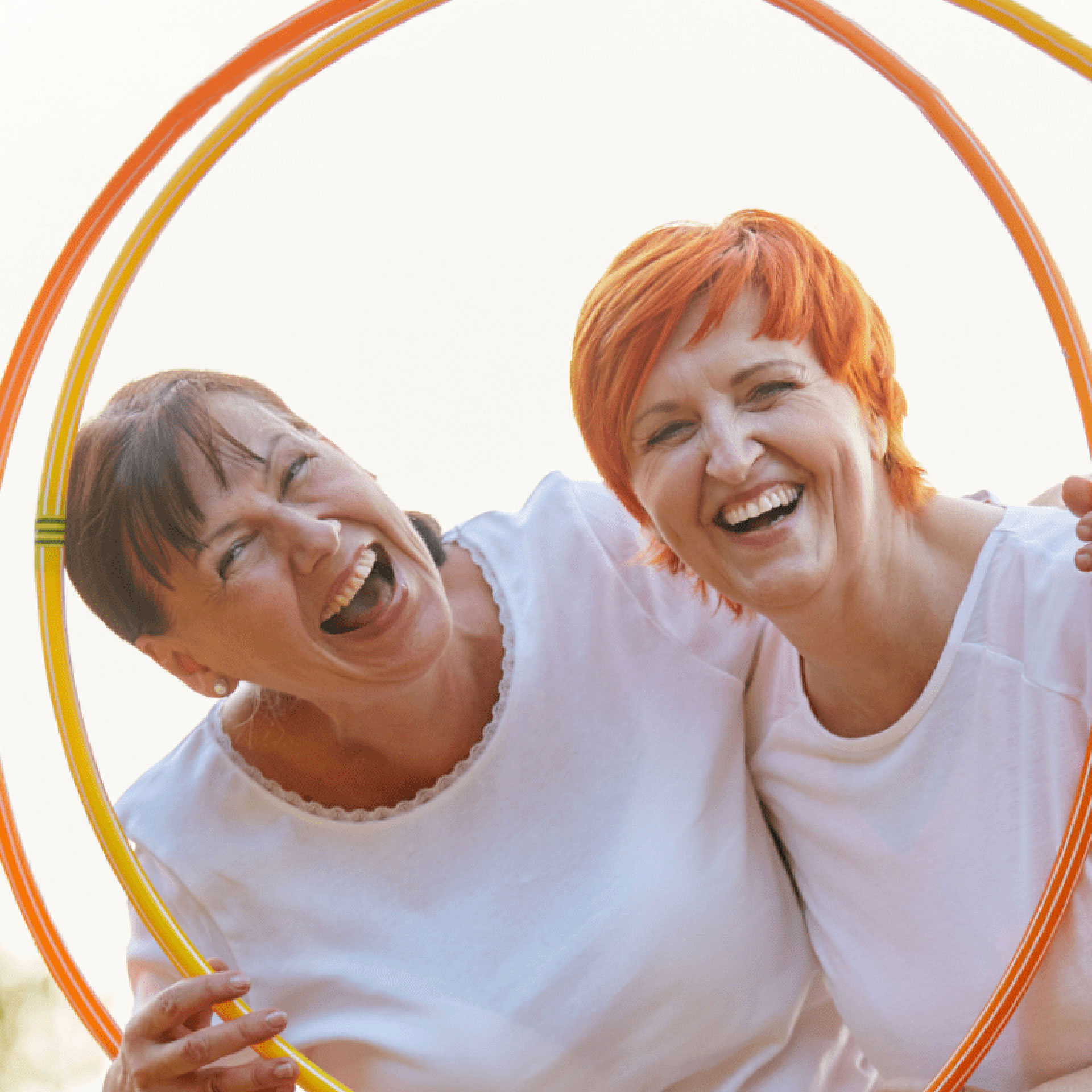 women holding hoola hoop